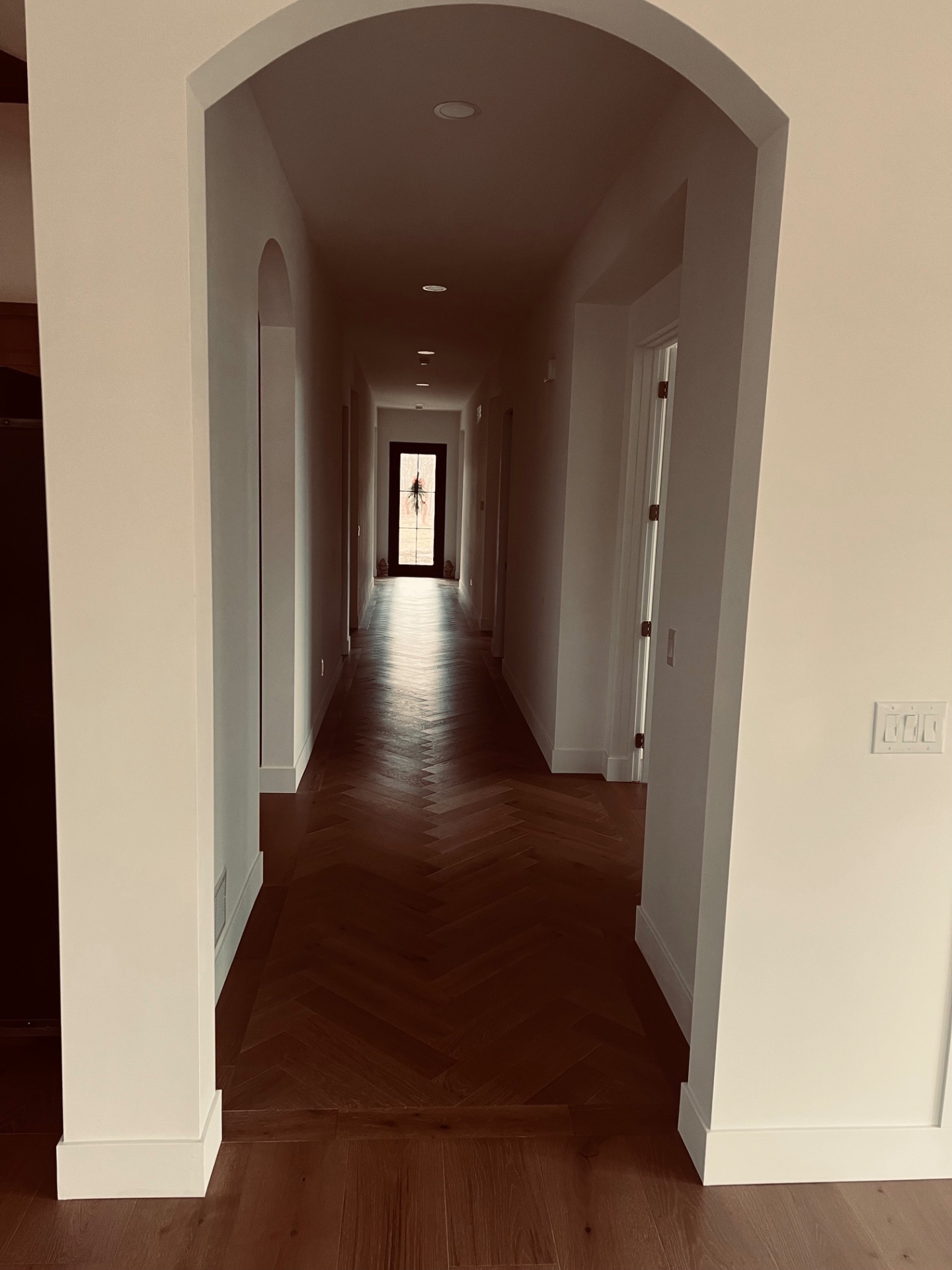 Arched Hallway with Herringbone Floors